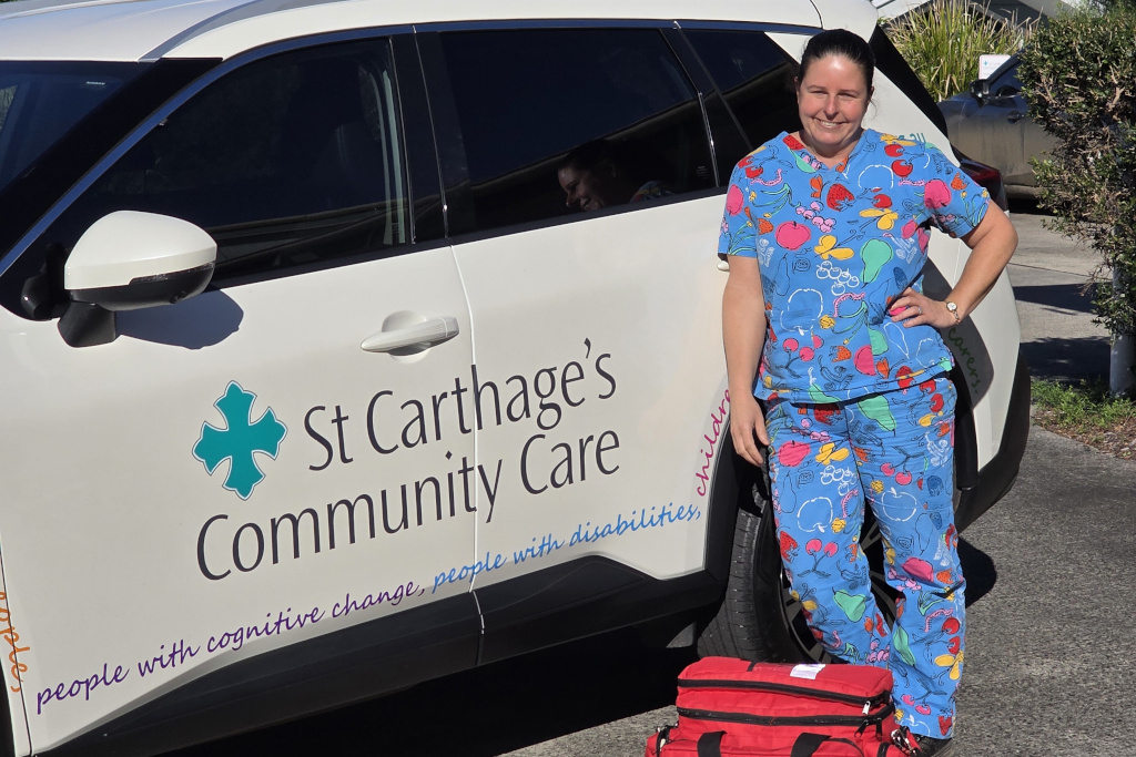 Nurse Nurse standing in front of a fleet car
